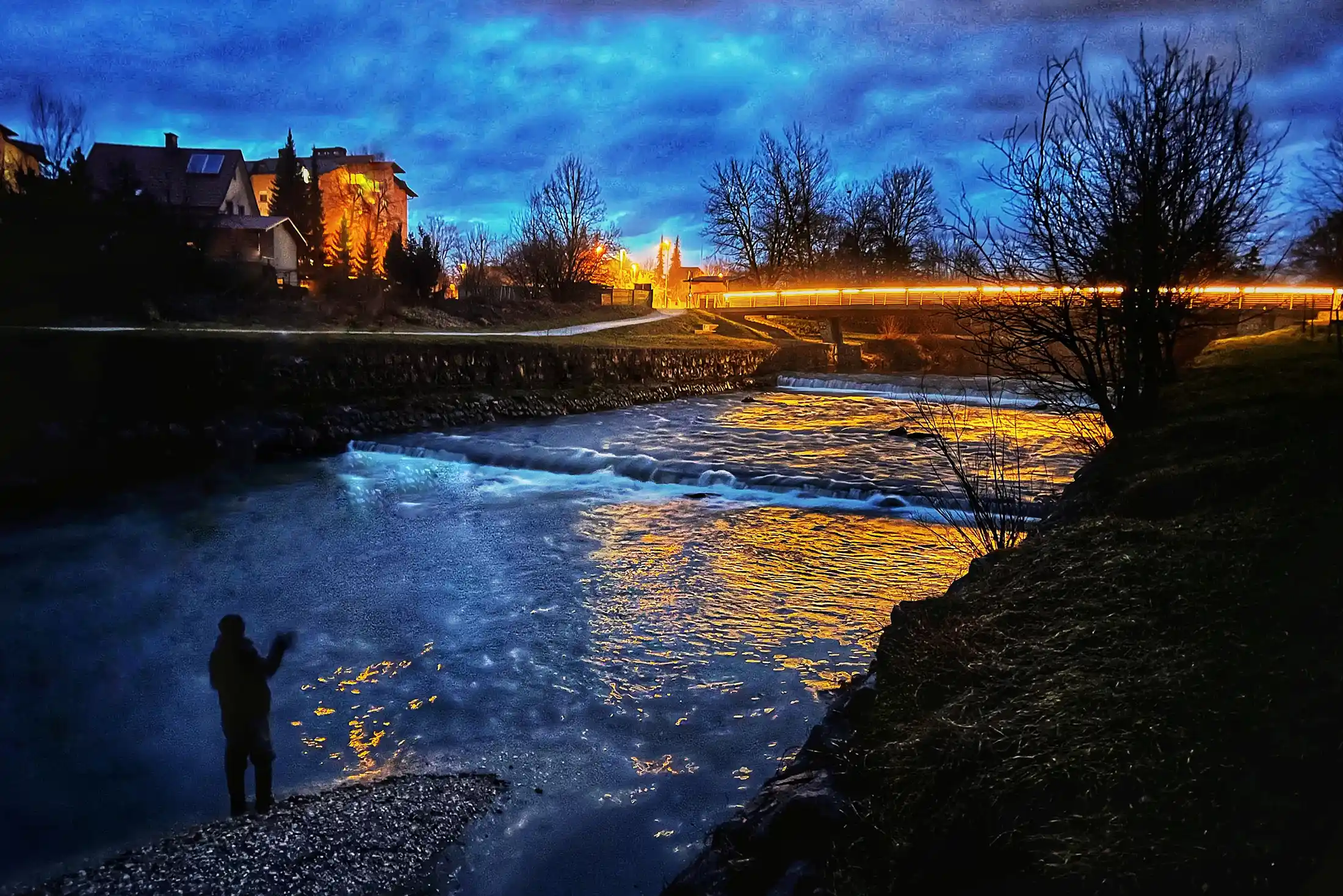 Fly angler in action for the last cast, pursuing hucho on Kamniška Bistrica, Slovenia.