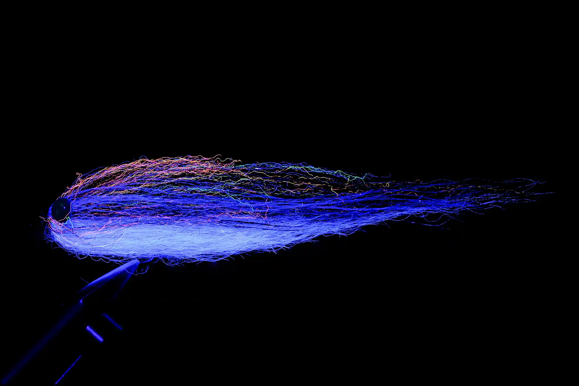 Hucho streamer tied by Michael Menardo, using Tommi Fly UV materials. Enlighted by UV light.
