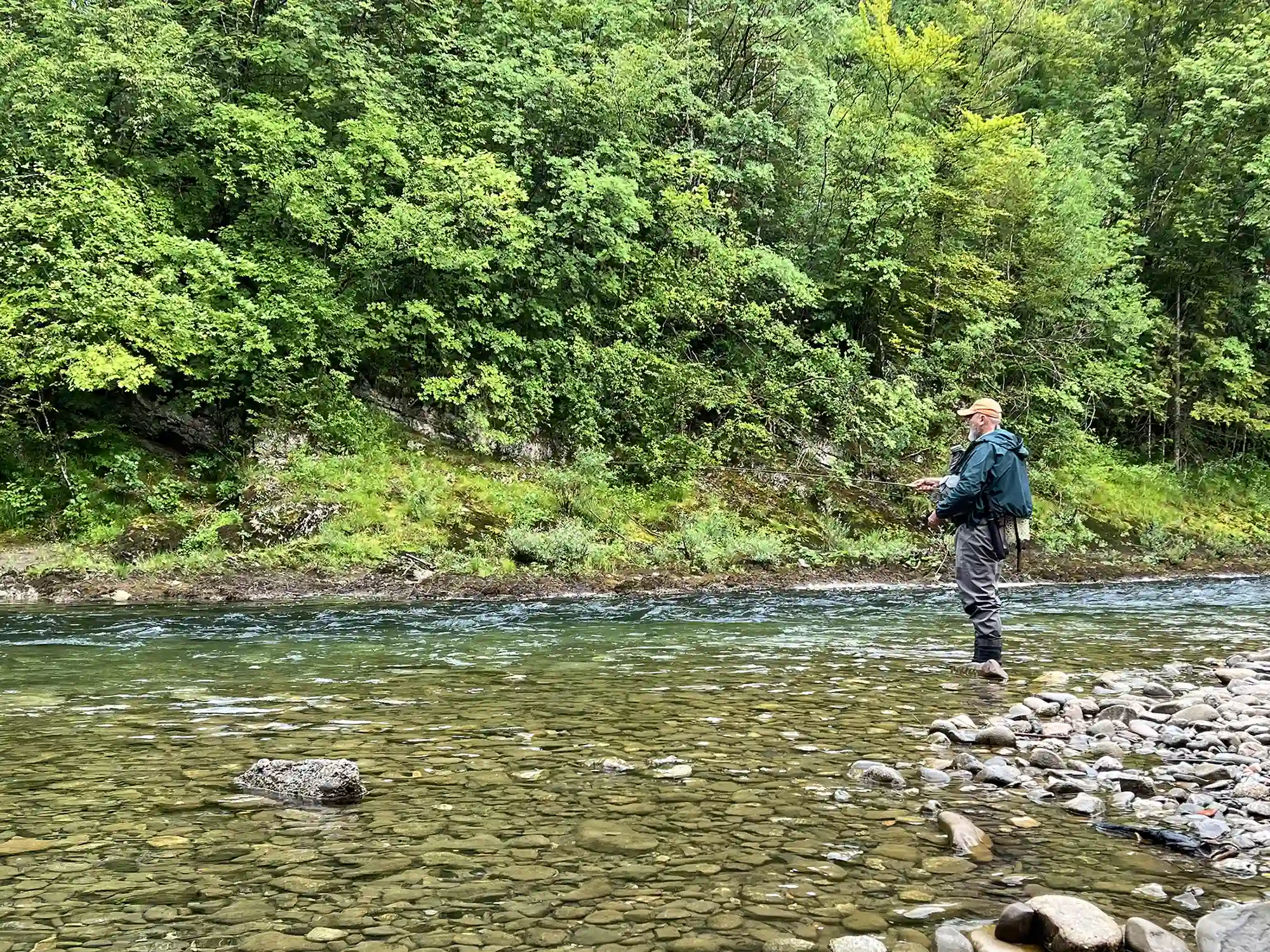 Kolpa river, Slovenia, dry fly fishing for grayling, angler in action.